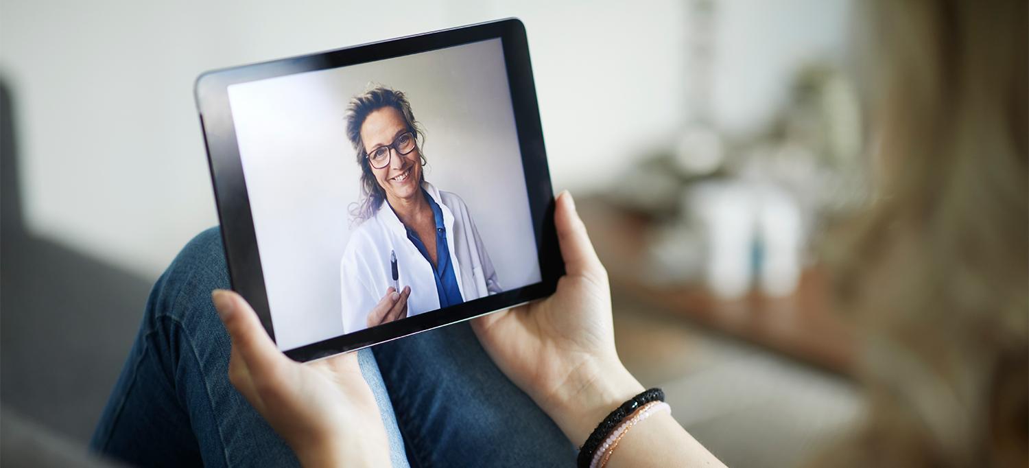 Person Using Tablet Device to Speak with Doctor