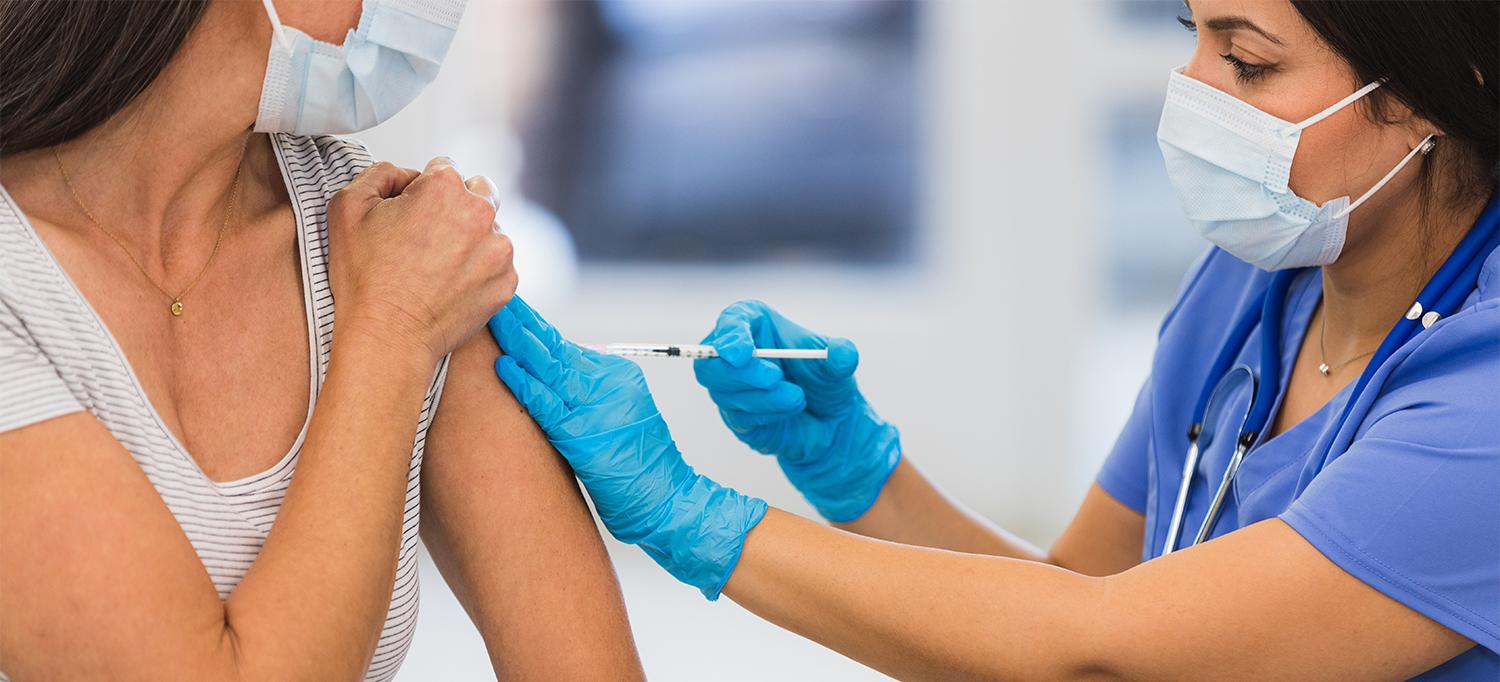 Person Receiving Vaccine Shot in Arm from Healthcare Professional
