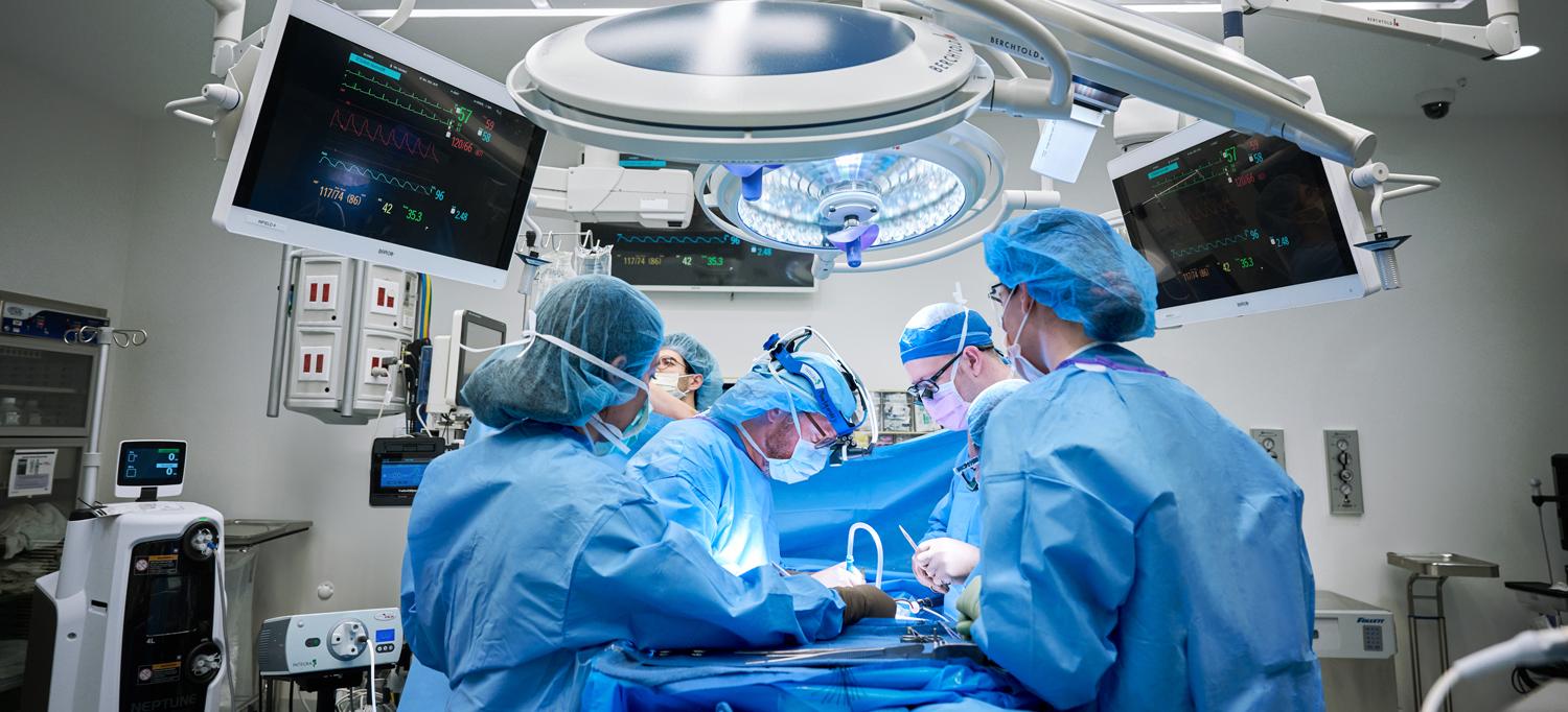 Team of surgeons performing procedure in NYU Langone operating room equipped with the latest technology