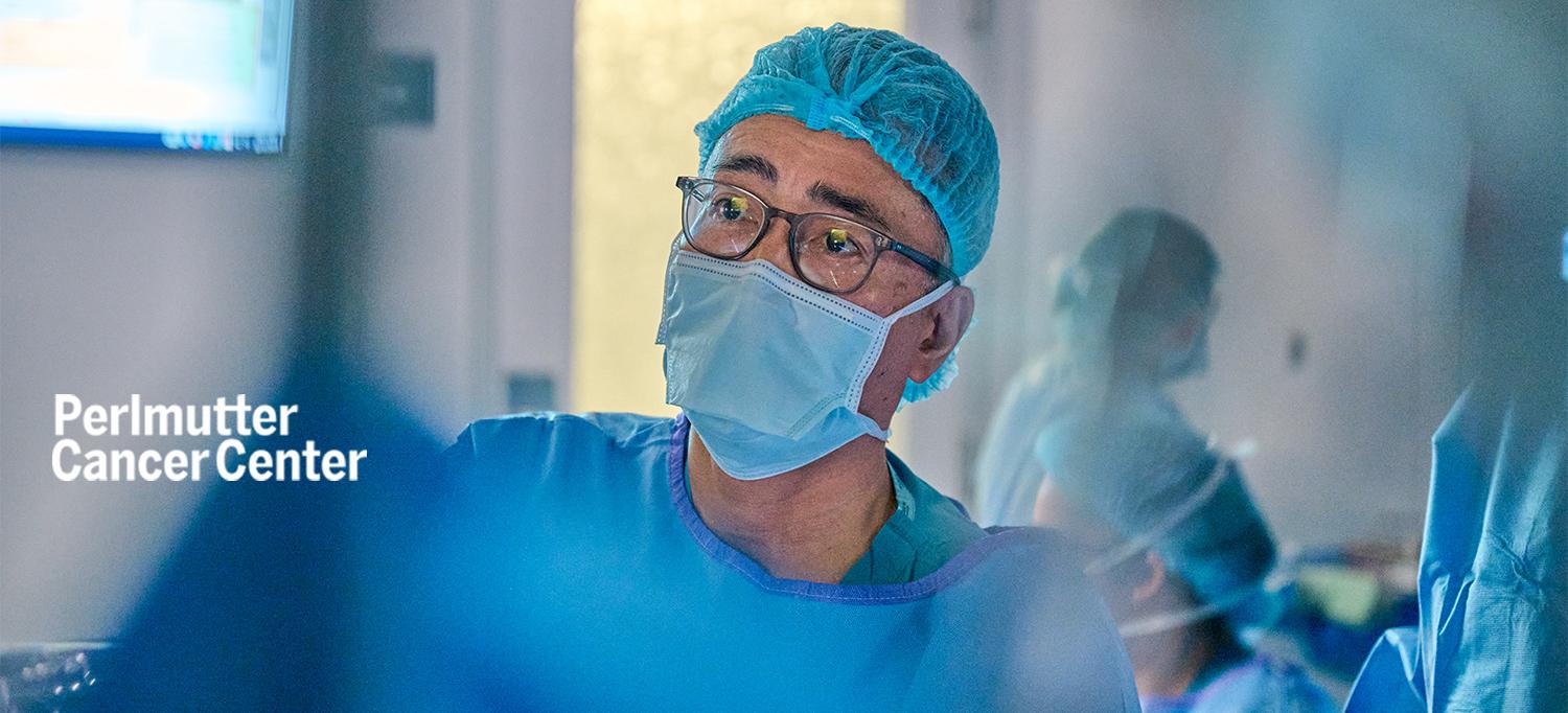 Dr. Toyooki Sonoda Wearing Cap, Face Mask, and Surgical Gown During Procedure in Operating Room