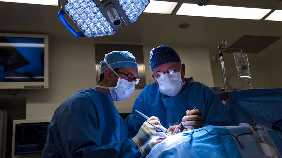 Dr. John Golfinos and Dr. J. Thomas Roland Perform Surgery