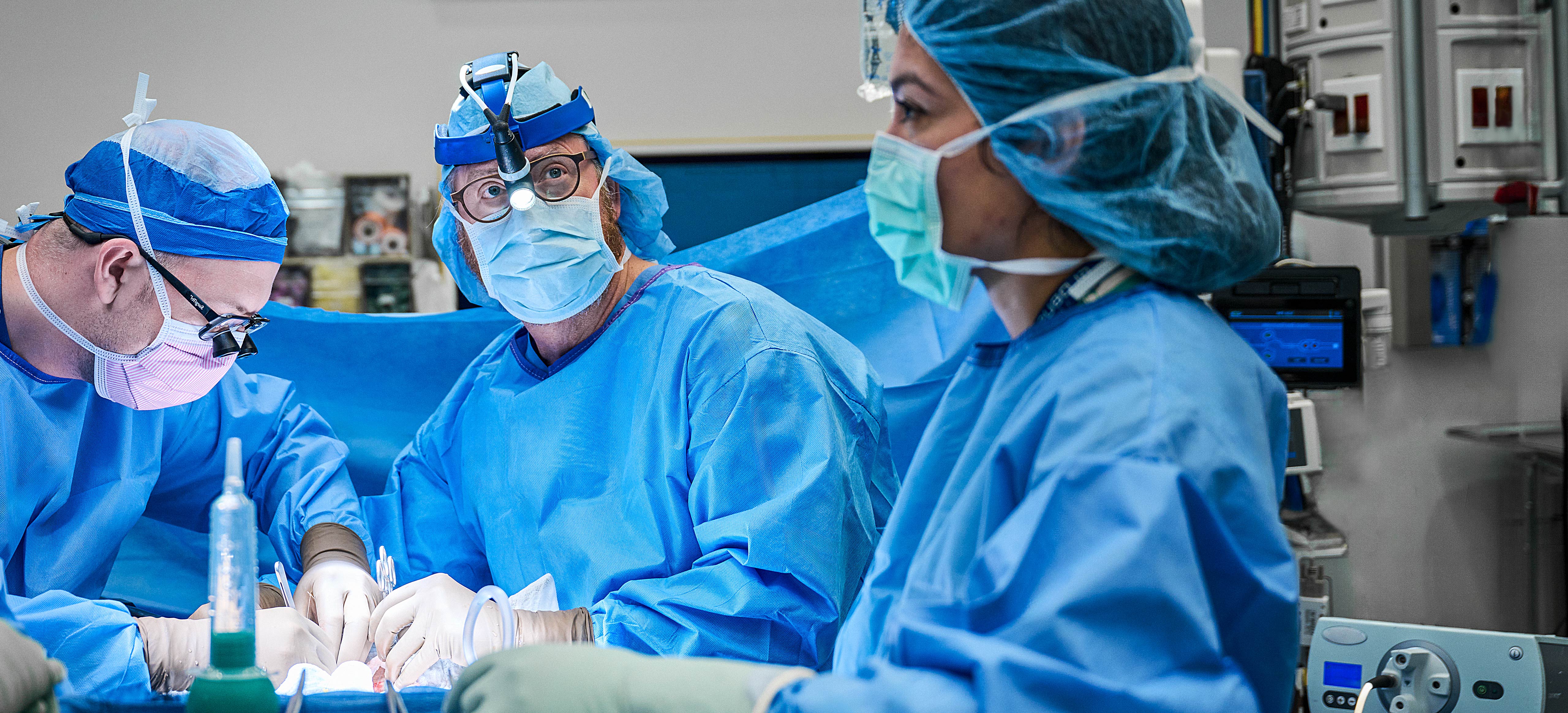 Dr. Robert Montgomery and team performing transplant surgery in operating room.