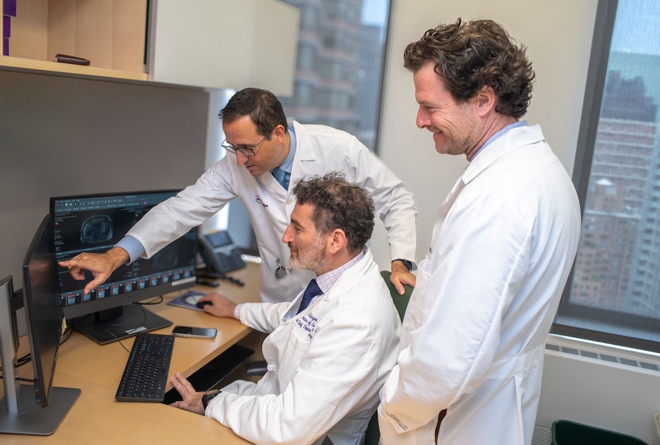 Dr. Augusto Villanueva Rodriguez, Dr. Karim J. Halazun, and Dr. Ryan M. Hickey review an image