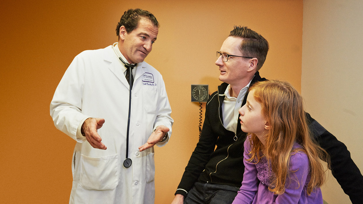 Doctor with Pediatric Patient and Father