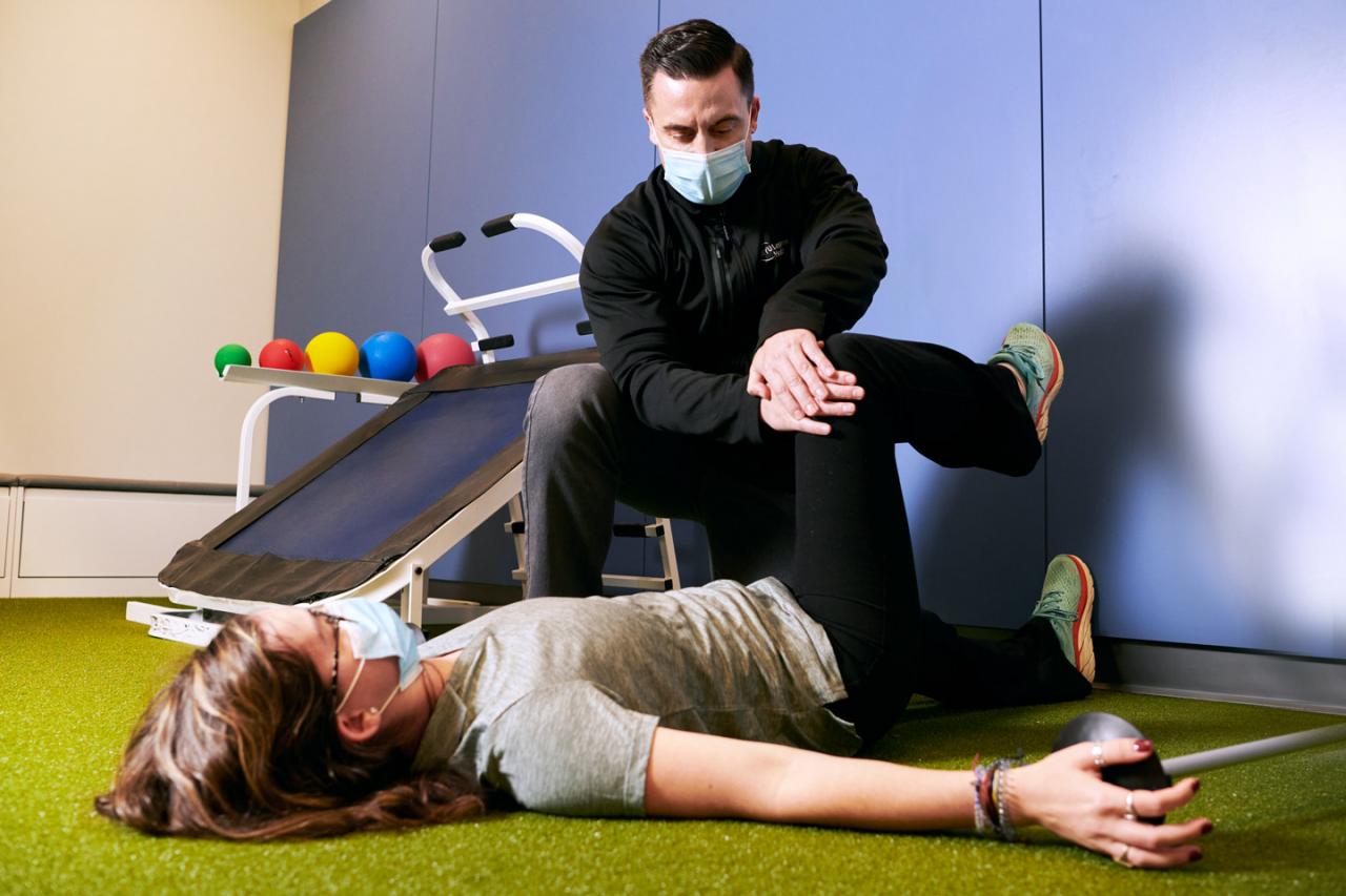 Physical Therapist with Patient in Gym