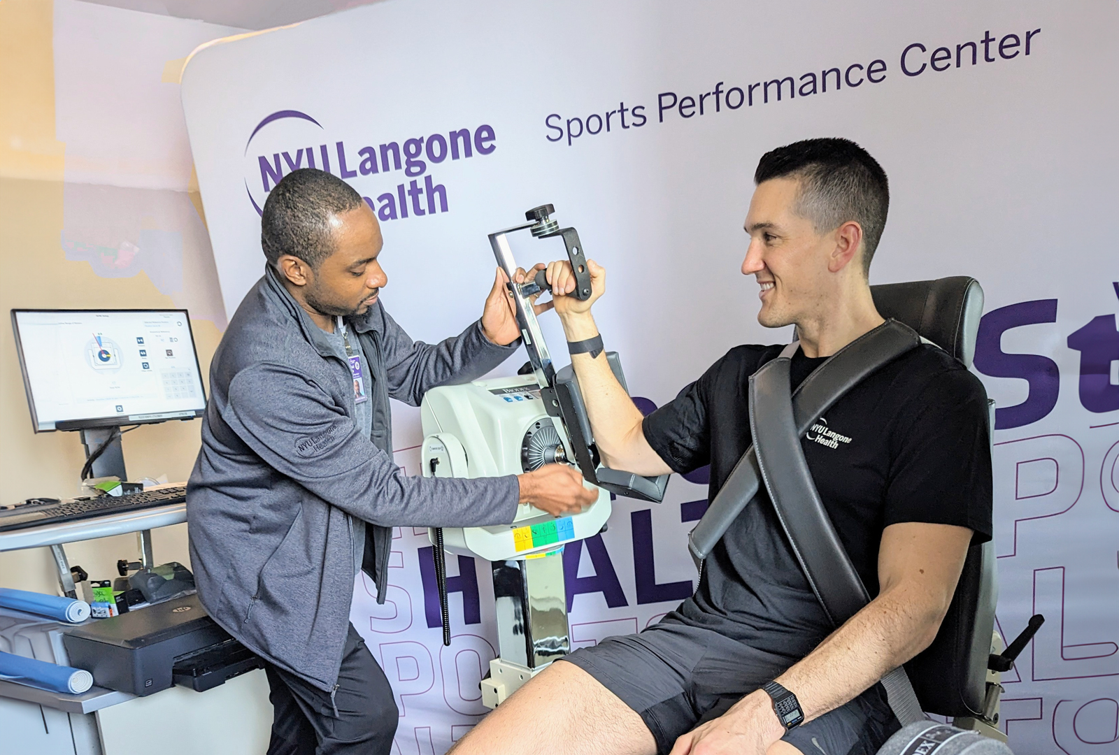 A specialist tests a patient’s arm at the Sports Performance Center.