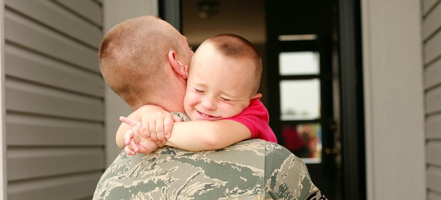 Child Hugs Father Returning from Military Duty