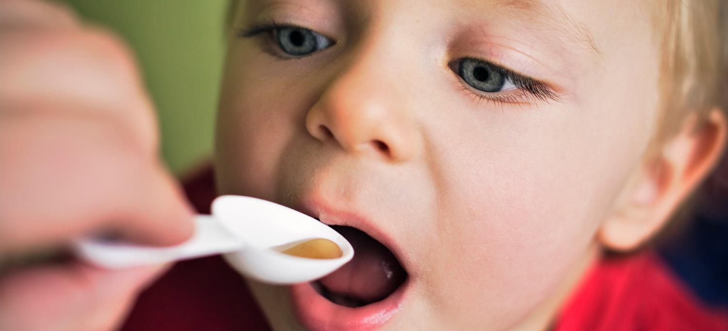 Child Takes Spoon of Antibiotic Medicine
