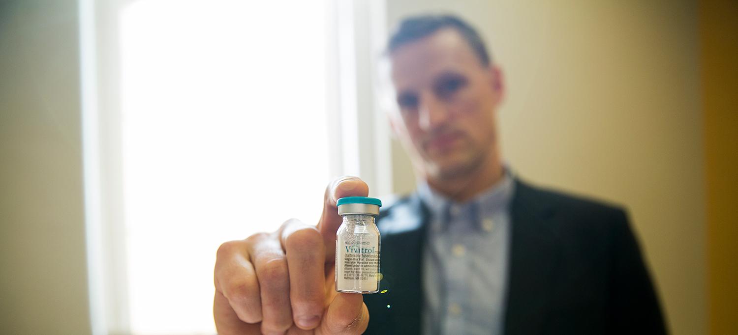 Researcher Holds Vial of Opioid Treatment