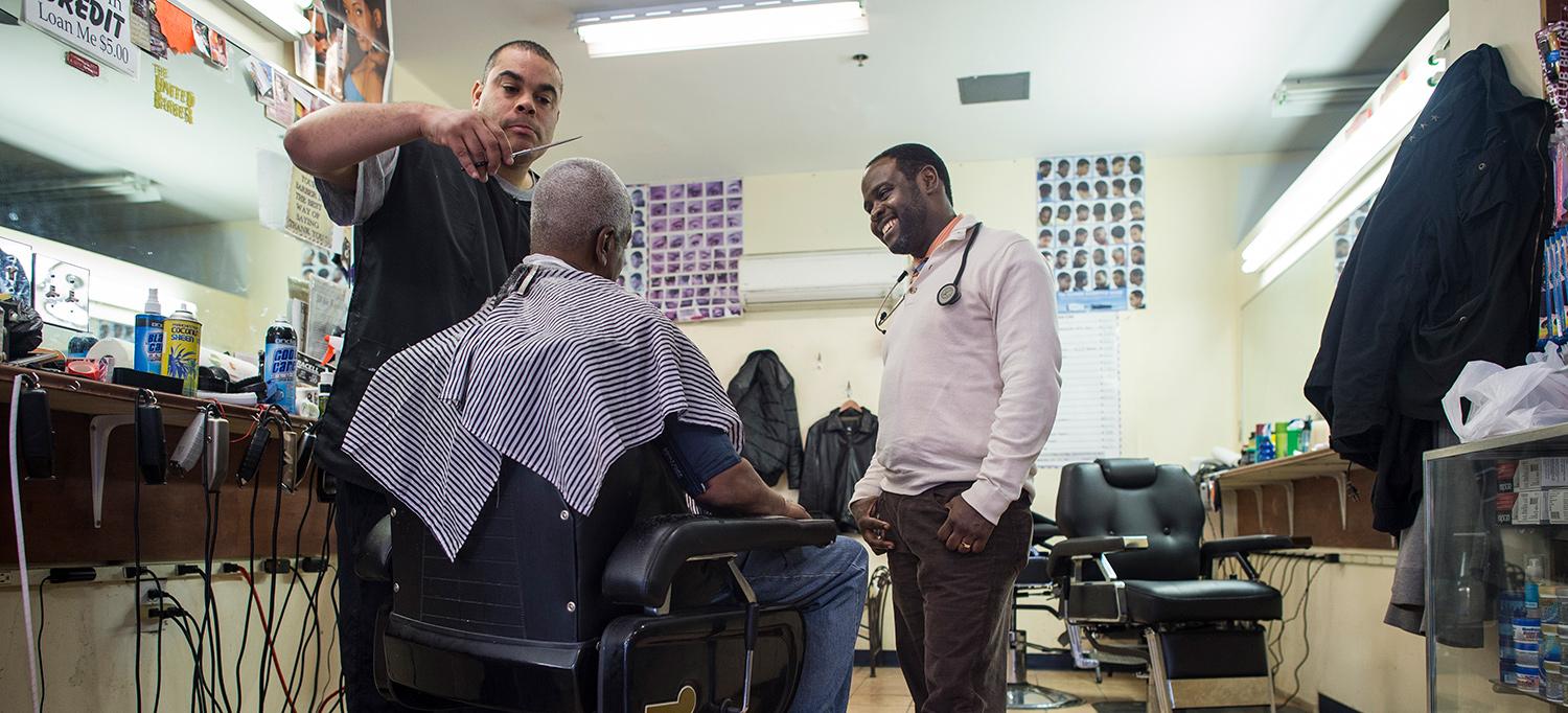 Dr. Joseph Ravenell Speaking with Man in Barbershop