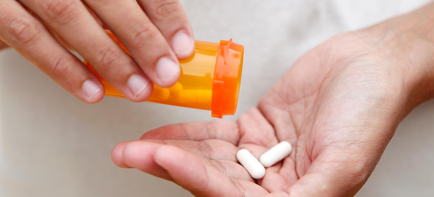 Hand Holding Prescription Pills