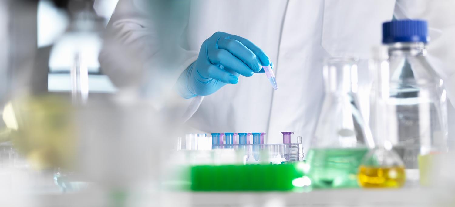 Scientist Holds Vials in Laboratory