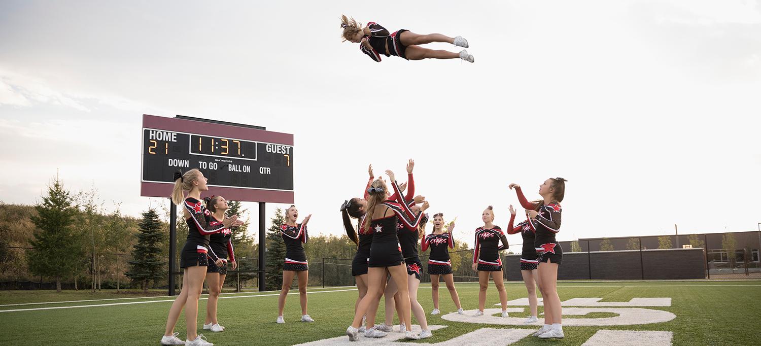 Cheerleaders Practicing Stunts