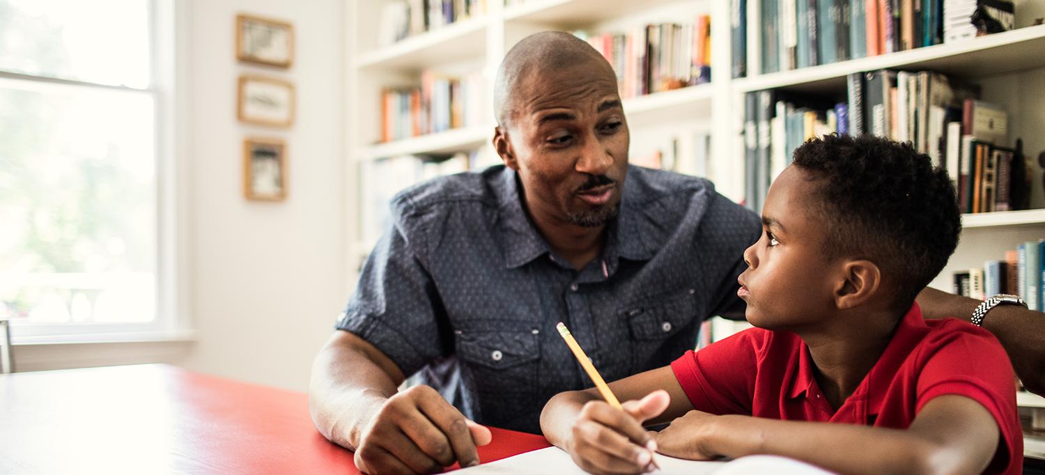 Man Helps Son with Homework