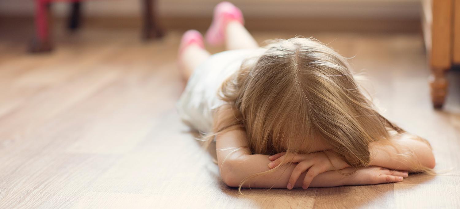 Child Lying Face Down on Floor