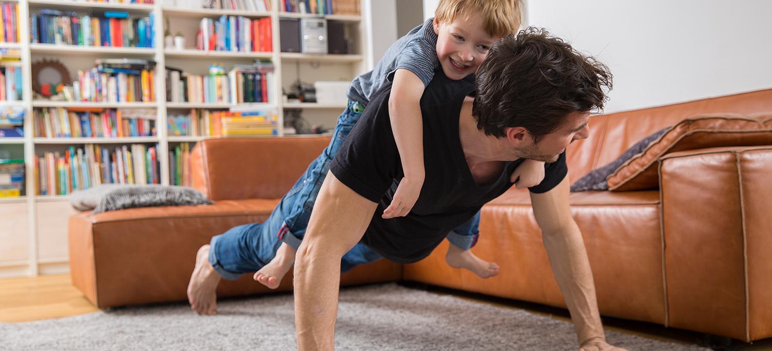 Man Does Push-Up with Child on Back