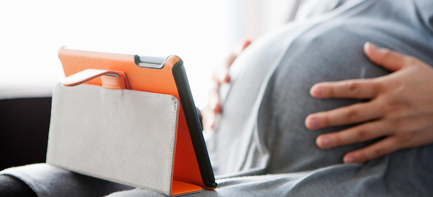 Pregnant Person Using Mobile Device