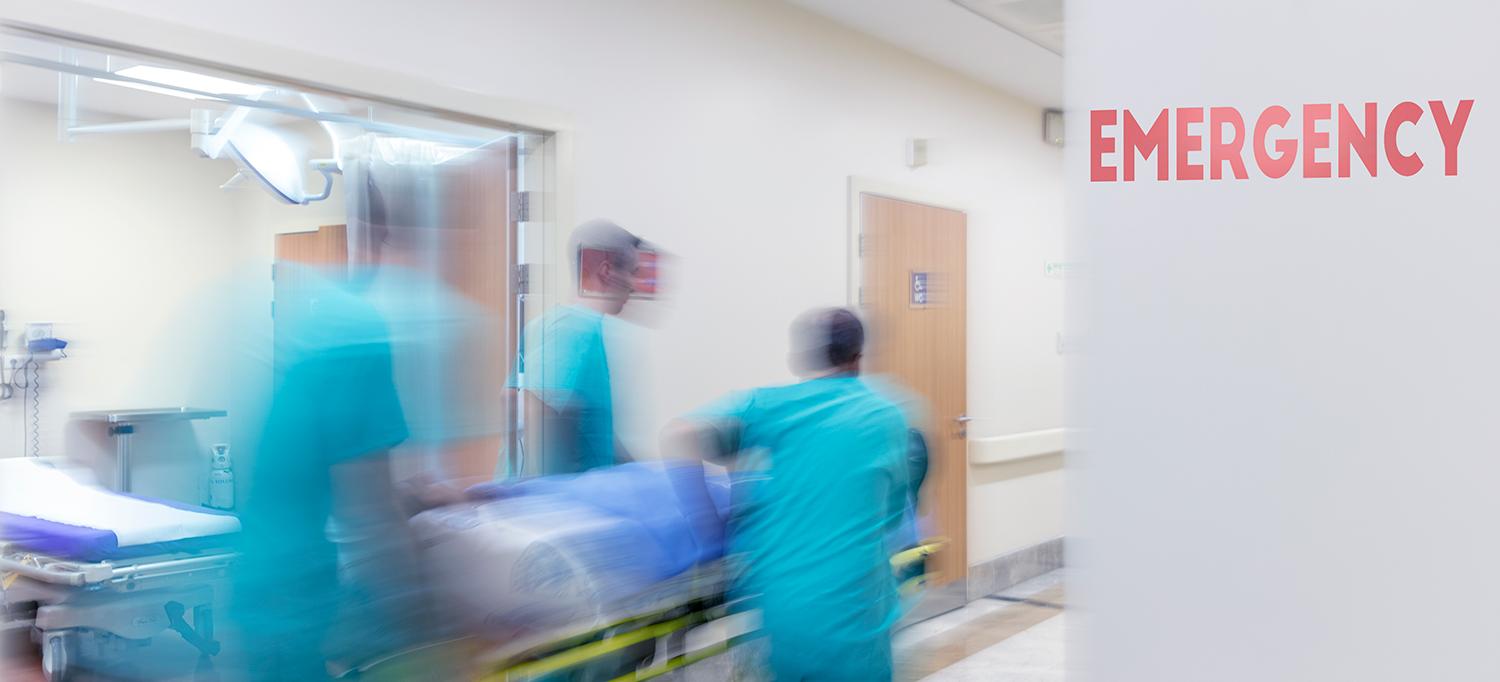 Care Providers with Transport Stretcher in Emergency Department