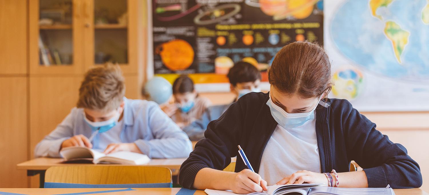 Students in Socially Distanced Classroom Wearing Masks and Doing Schoolwork