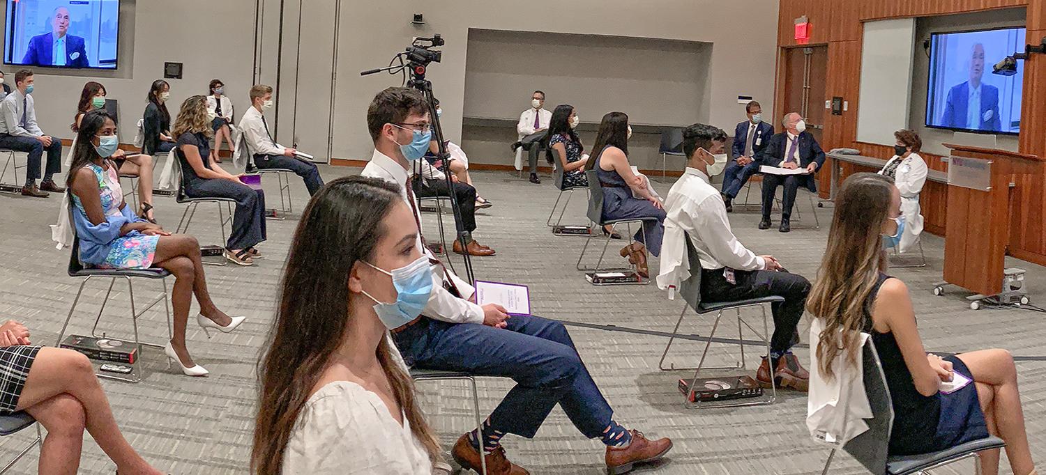 Medical Students Wearing Face Masks in Socially Distanced White Coat Ceremony