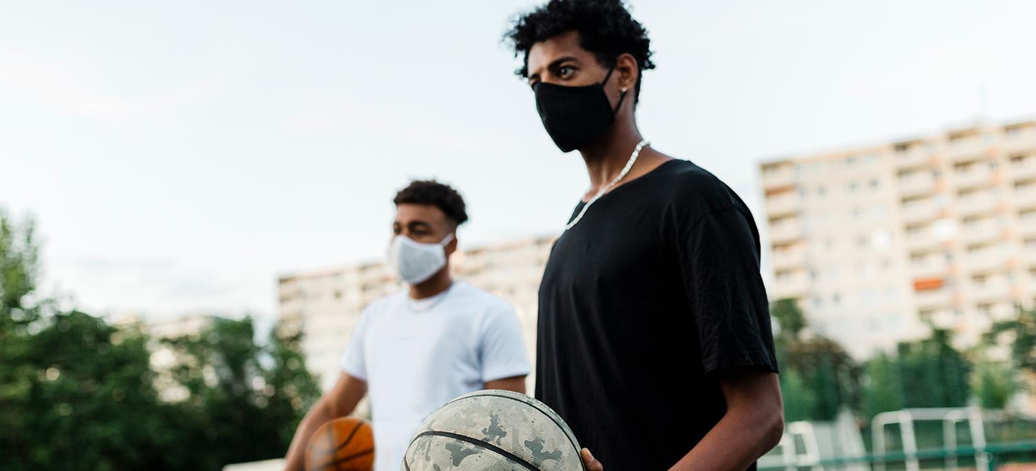 Young Men in Protective Masks with Basketballs in the Park