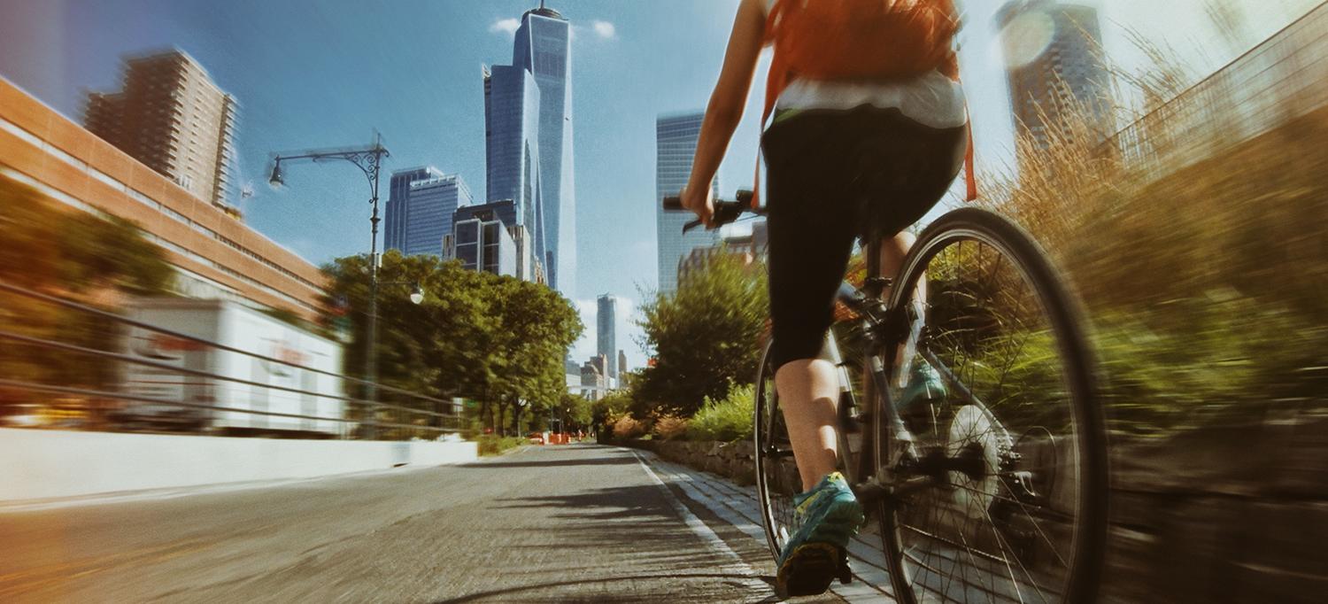 Person Cycling Through City