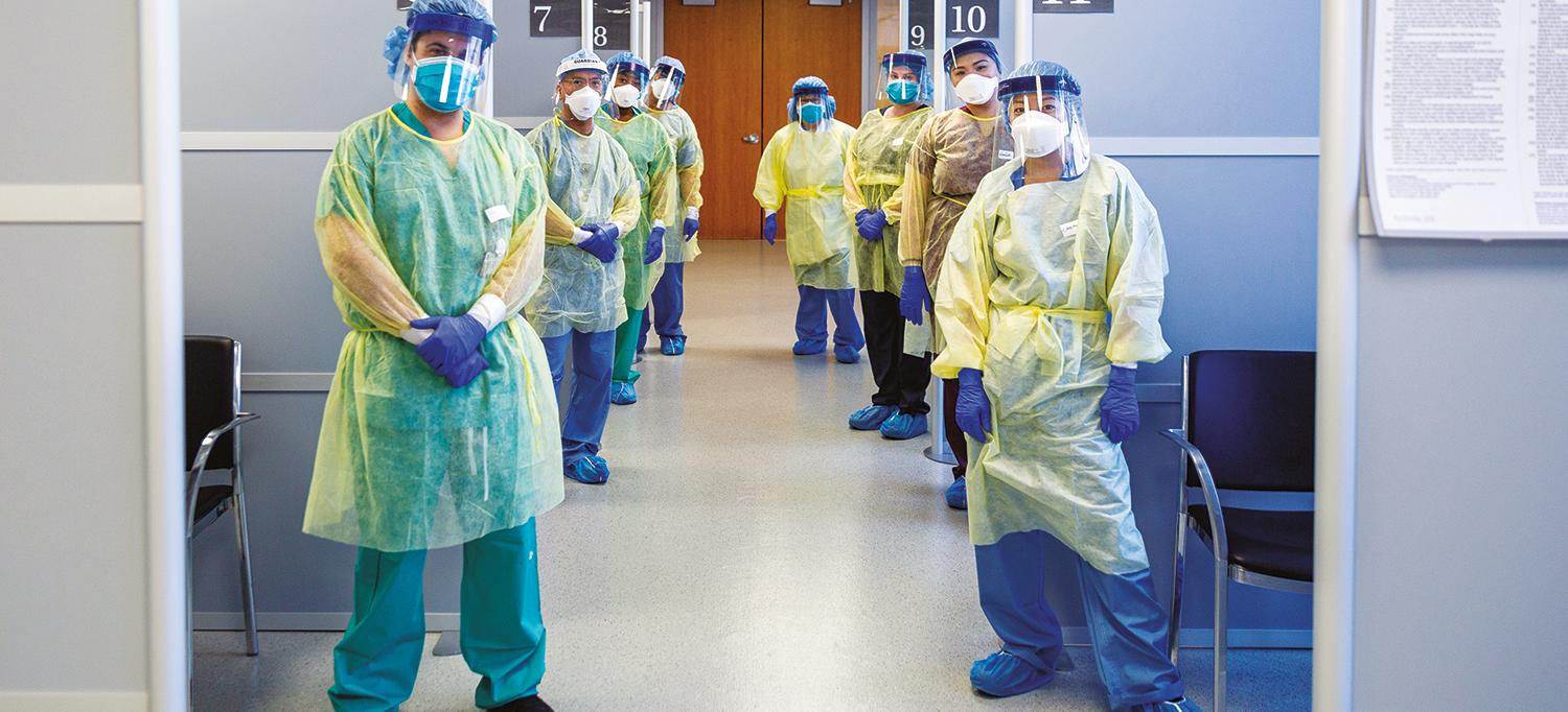 Healthcare Providers Lined Up Wearing Full Personal Protective Equipment