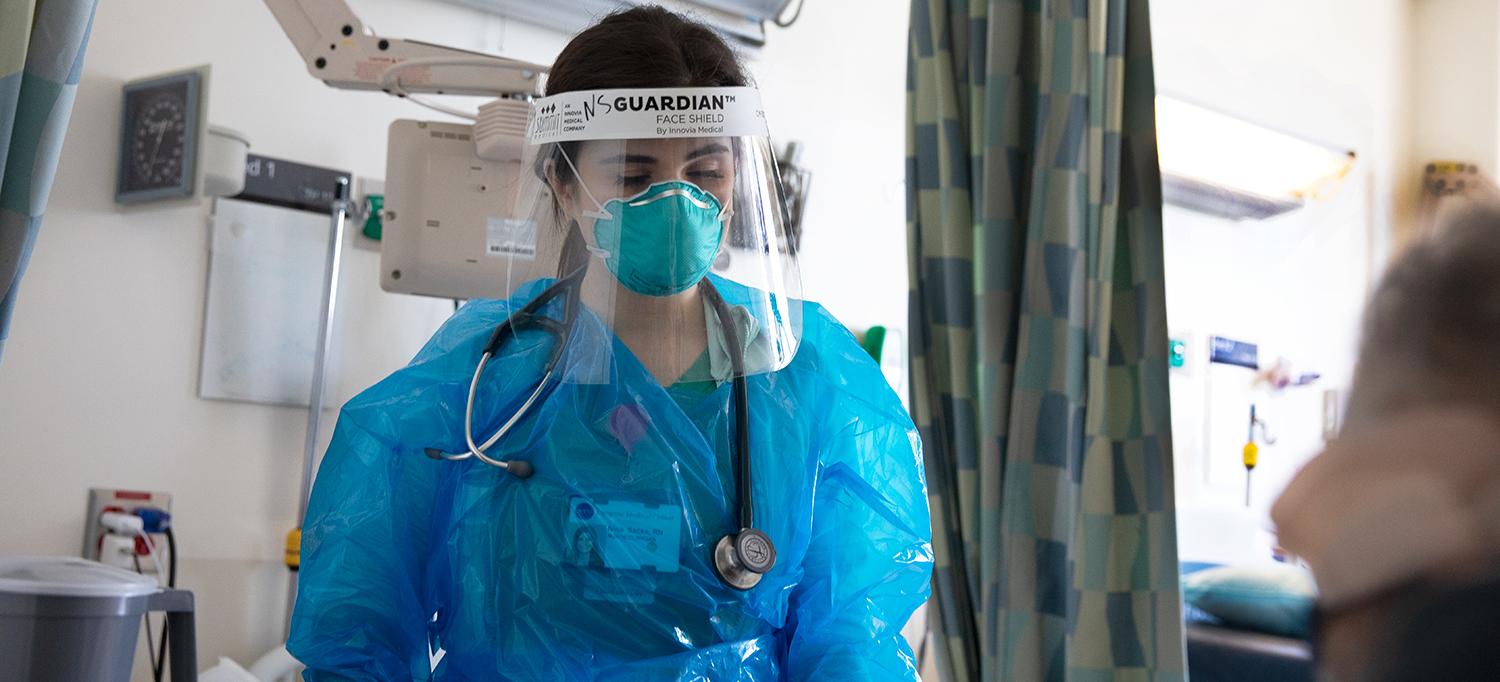 Nurse Clinician Nina Sacks Wearing Personal Protective Equipment with Patient