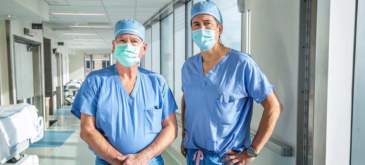 Dr. Aubrey C. Galloway and Dr. Thomas Maldonado Wearing Surgical Scrubs and Face Masks