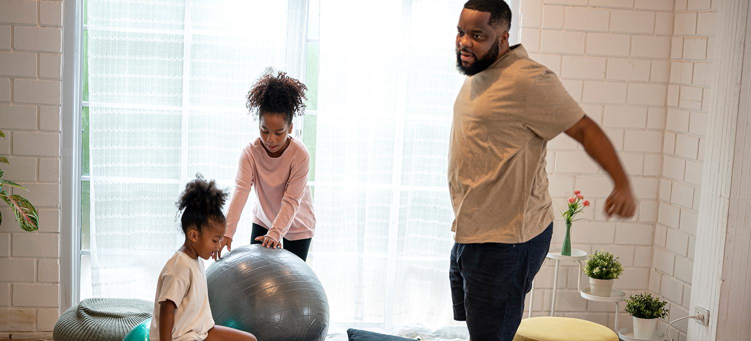 Father and Two Kids Exercising at Home