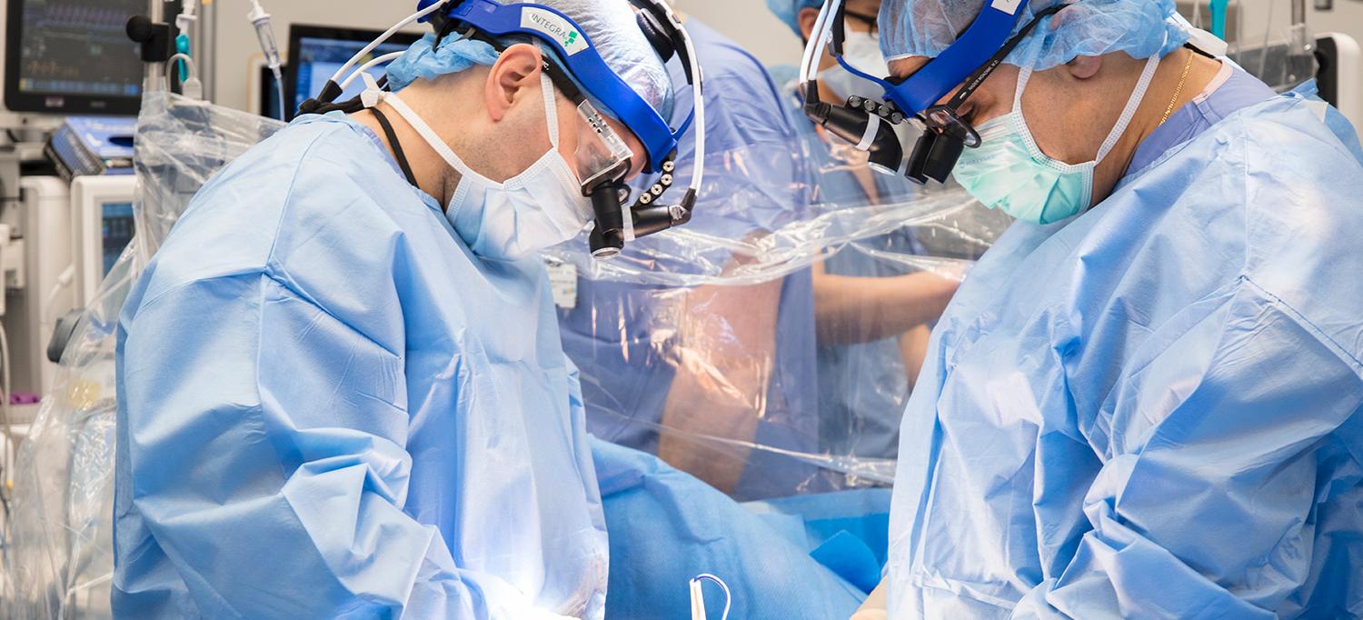 Dr. Nader Moazami, Dr. Deane E. Smith, and Team Performing Surgery