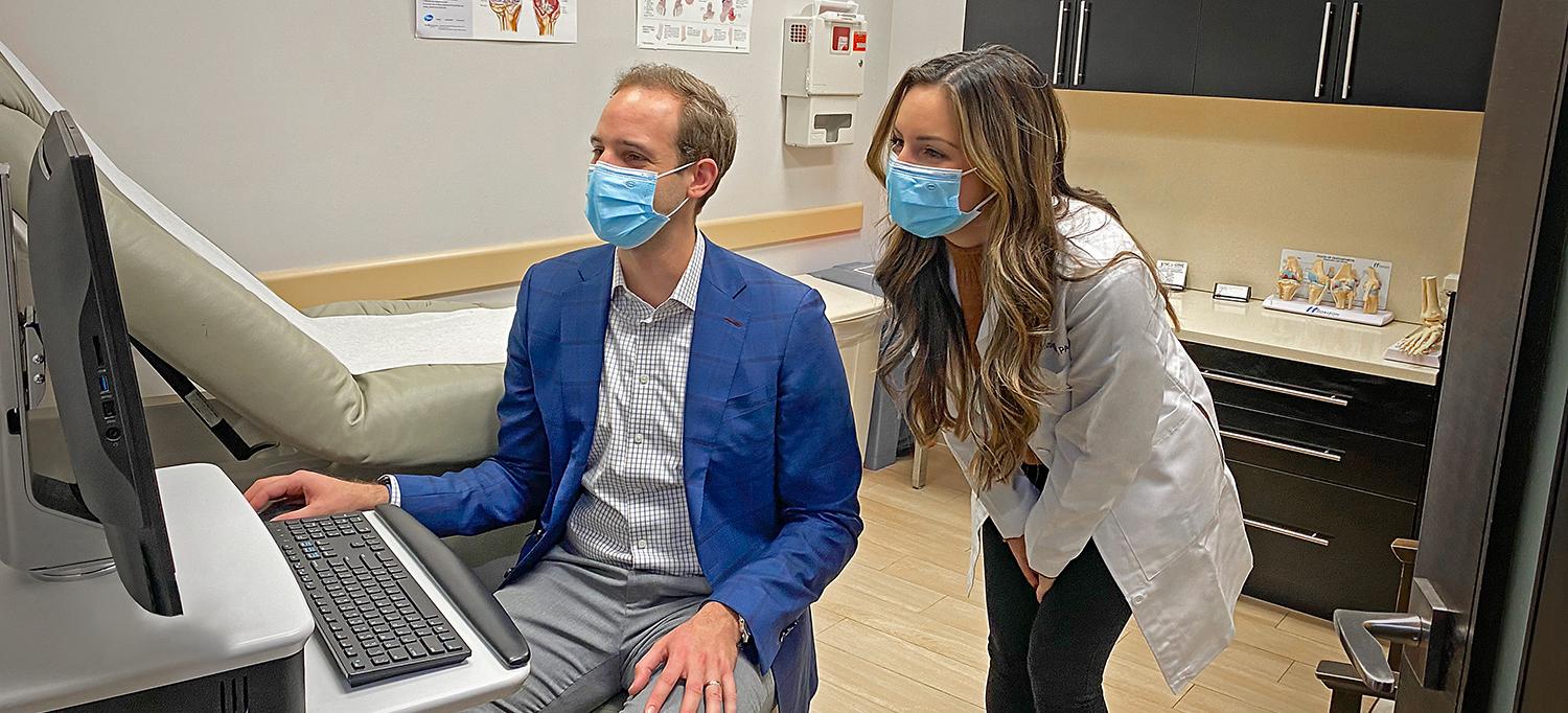 Dr. Spencer Stein and Physician Assistant Elaina Consiglio Viewing Computer Screen in Exam Room