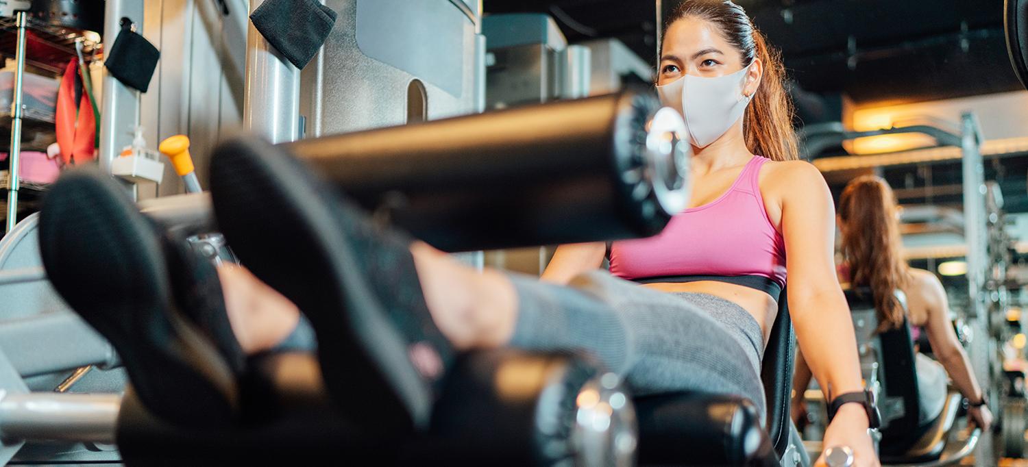 Woman Wearing Face Mask Working Out in Gym
