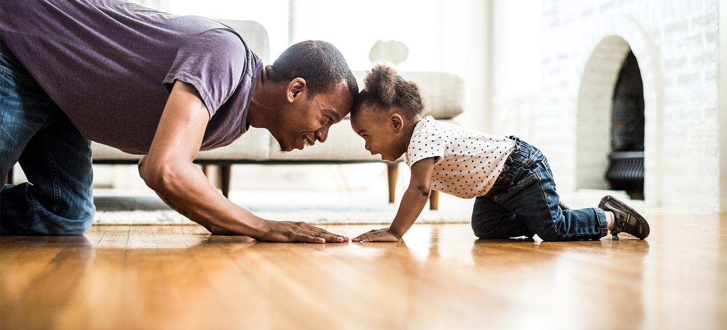 Father and Young Daughter Playing Together on Floor