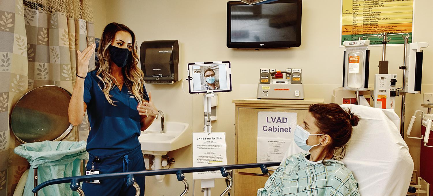 Christopher Kuhner and Dr. Victoria Terentiev Consult with a Patient at the Bedside