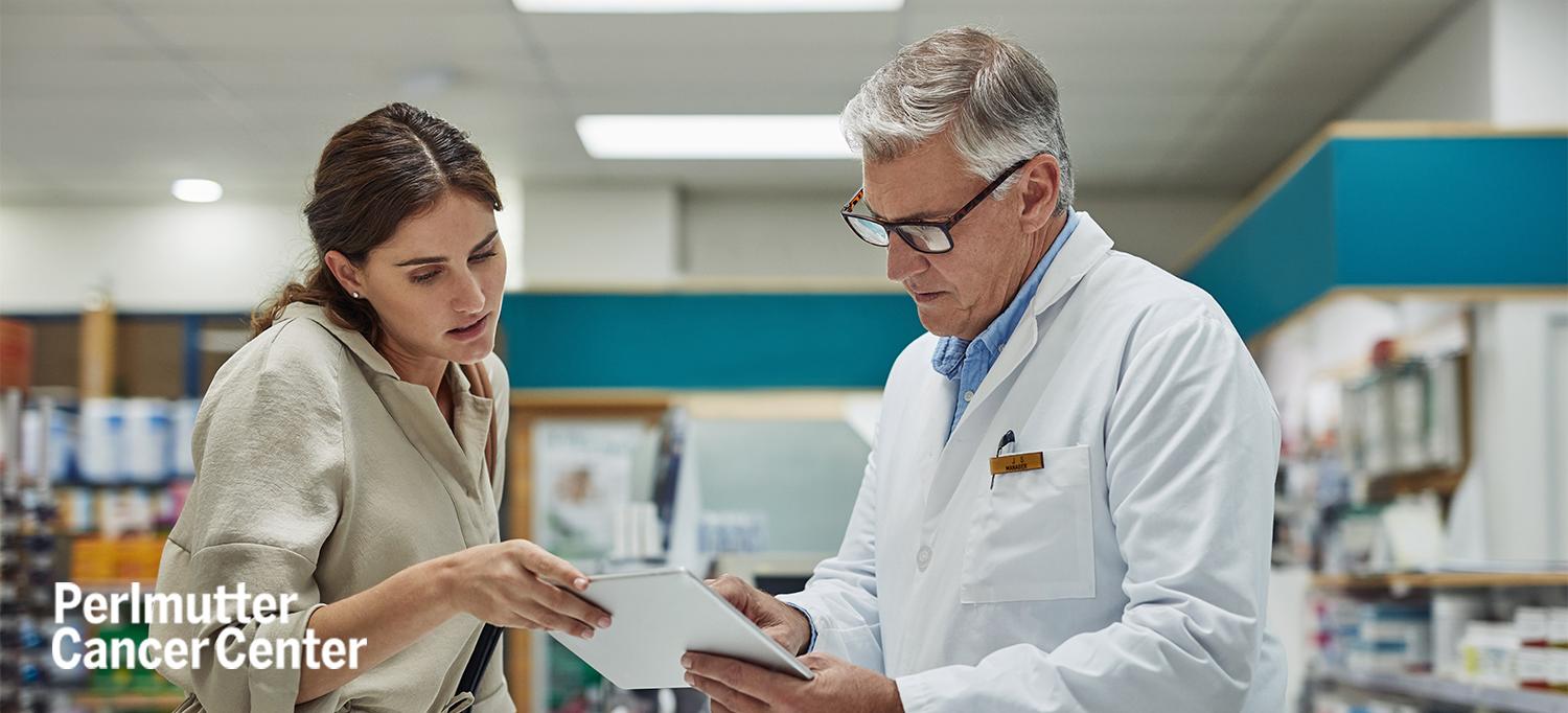 Doctor Reviewing File with Patient