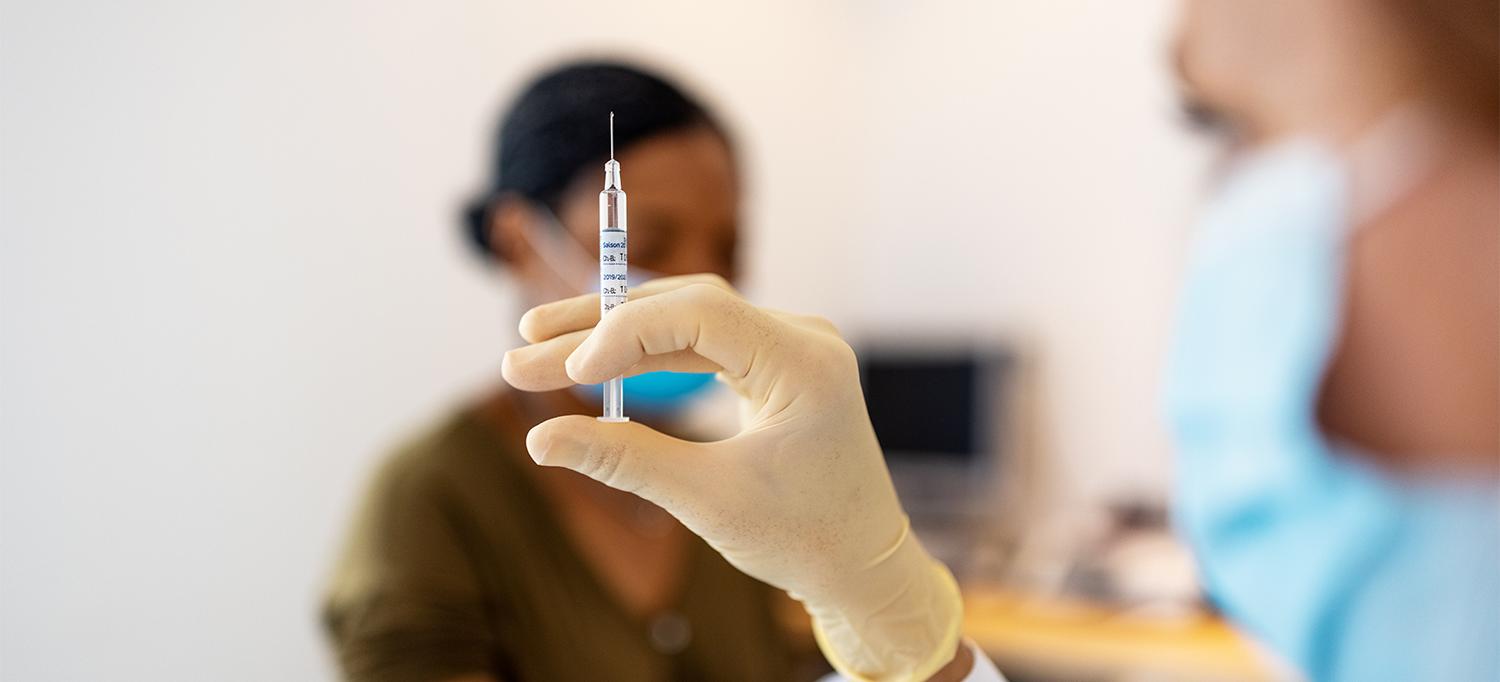 Healthcare Provider Holding Hypodermic Syringe