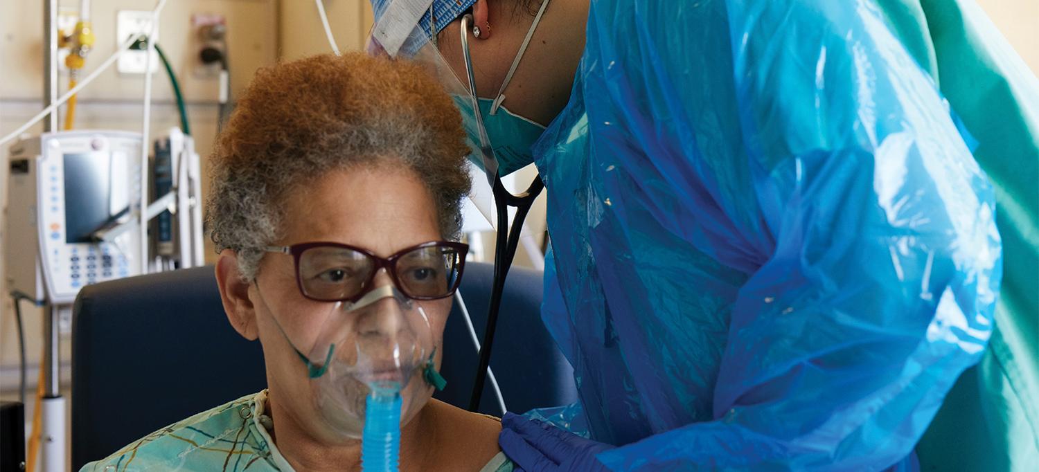 Doctor Examining Patient Wearing Oxygen Mask