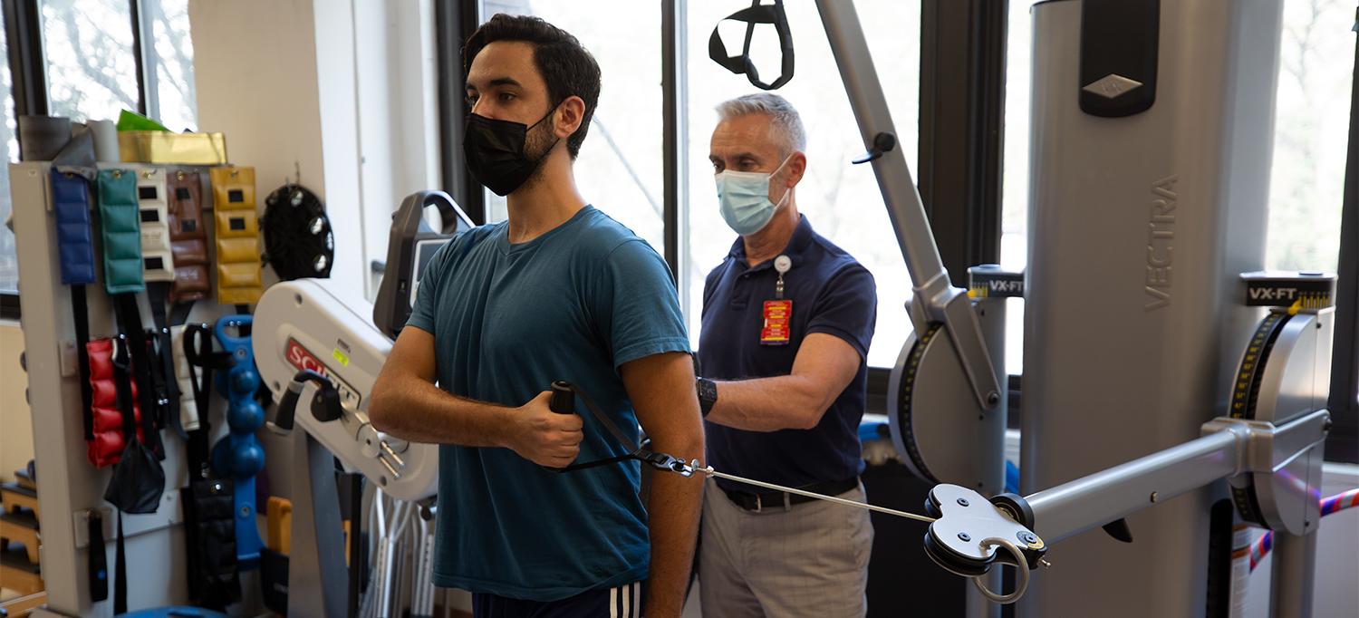 Mark E. Hall Assists Alex Aquilino in Physical Therapy Session