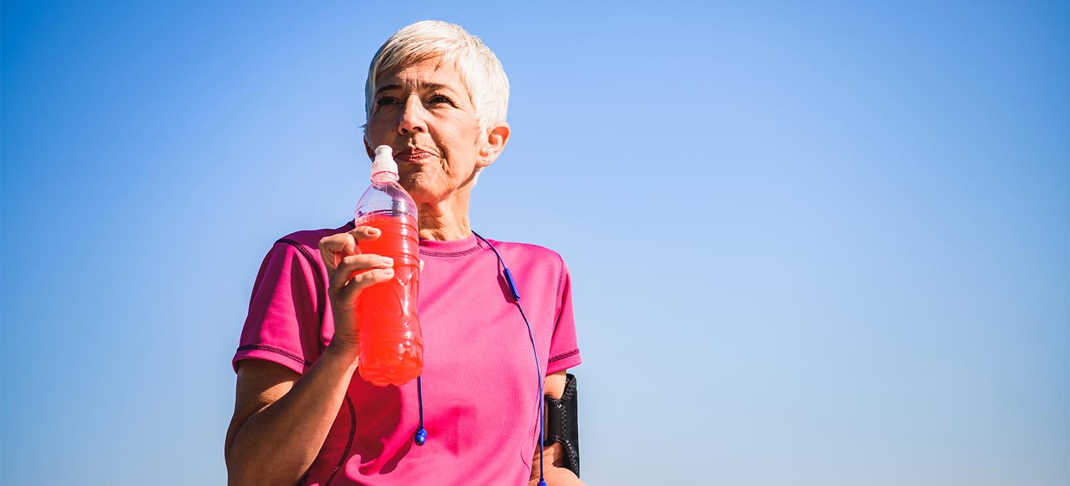 Person Taking Break from Exercise Outside with Sports Drink