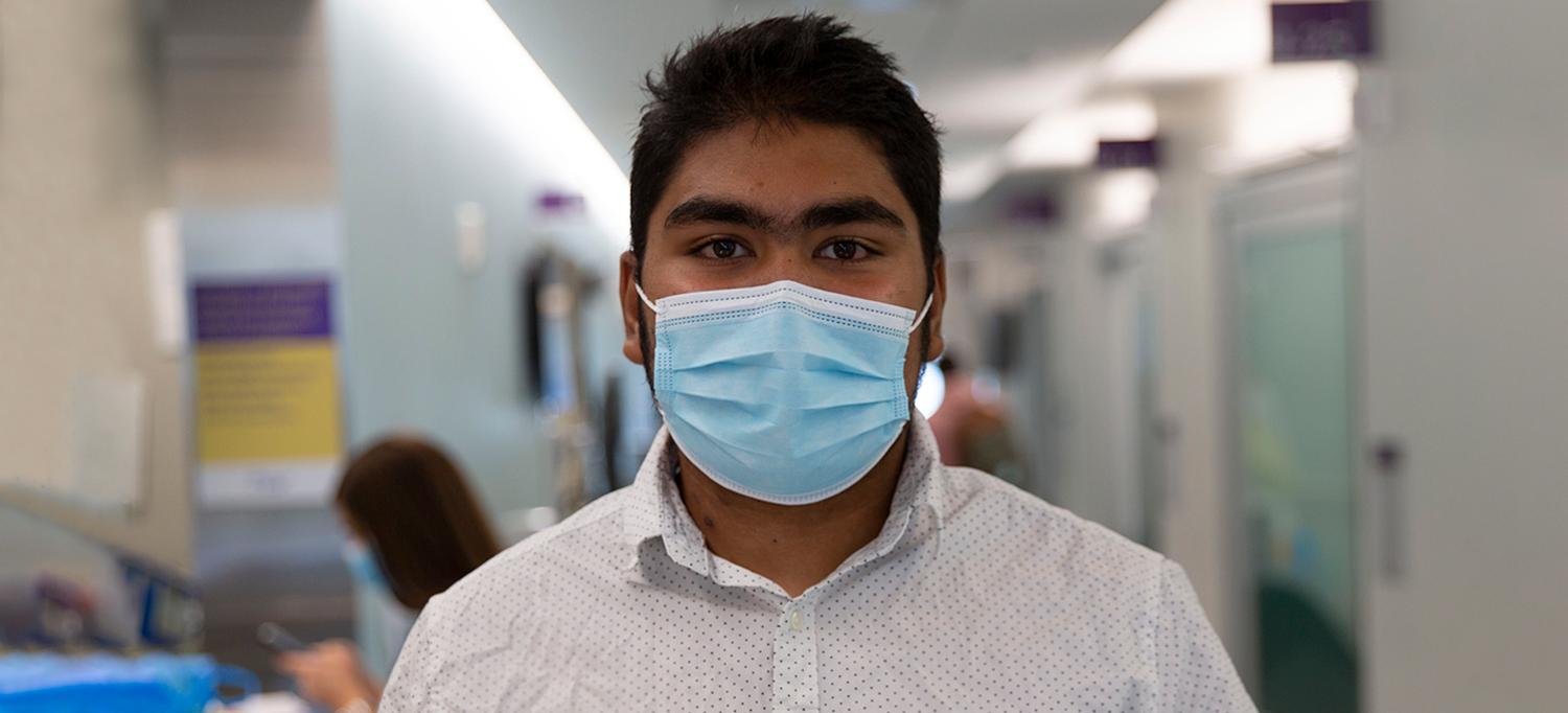 Maz Zisan Wearing Face Mask in Hospital Hallway