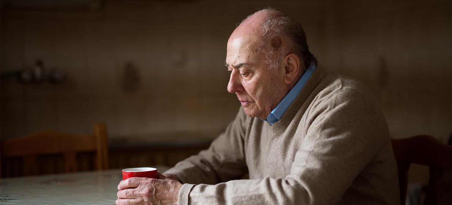 Older Adult Sitting By Himself at a Table