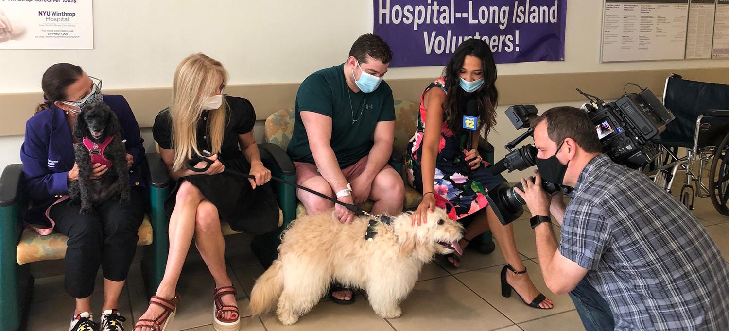 Patient and Volunteers with Dogs Being Interviewed by News Team