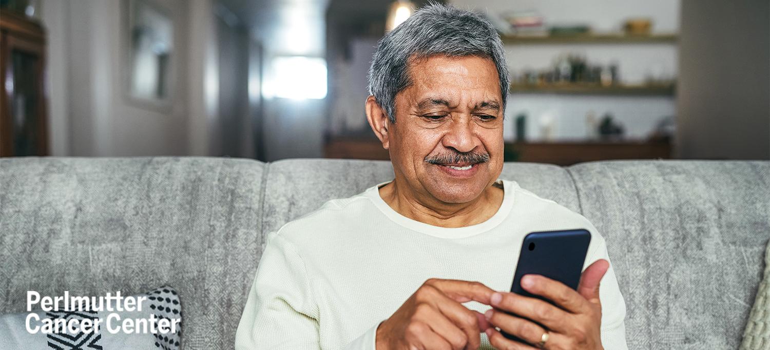Person Sitting on Couch Using Smartphone