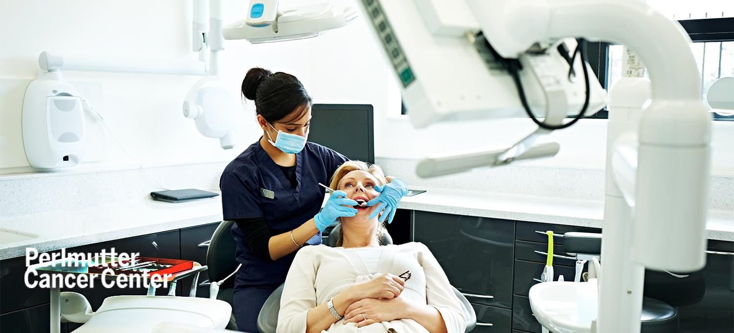 Dentist Checking Patient’s Teeth in Exam Room