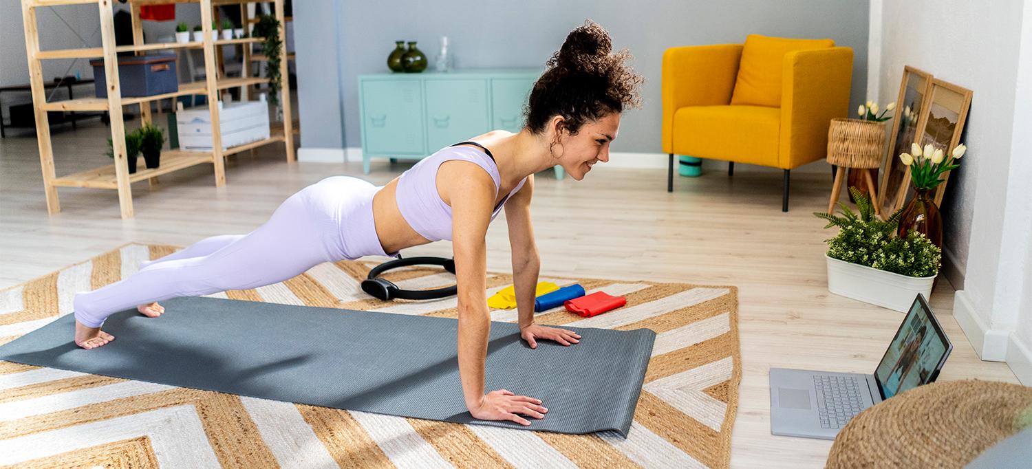 Person Practicing Yoga on Mat in Living Room