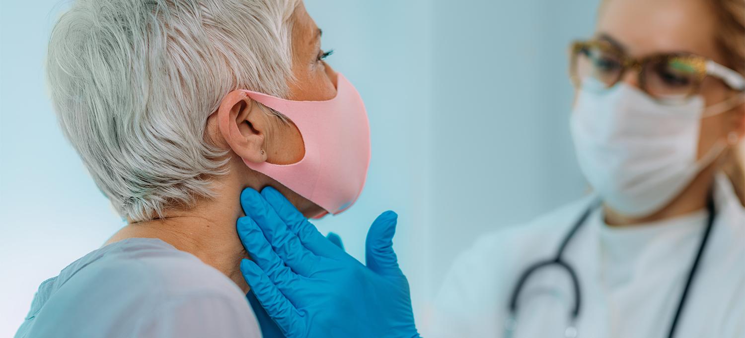Healthcare Professional Examining Person’s Thyroid and Neck