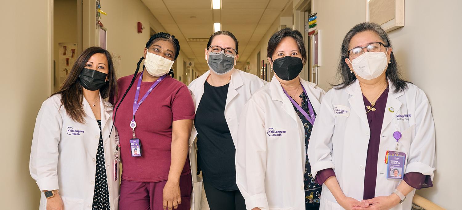 Five Female NYU Langone Health Employees in Hospital Hallway