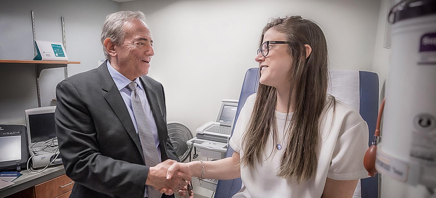 Catherine Shakes Hands with Dr. Larry A. Chinitz in Exam Room