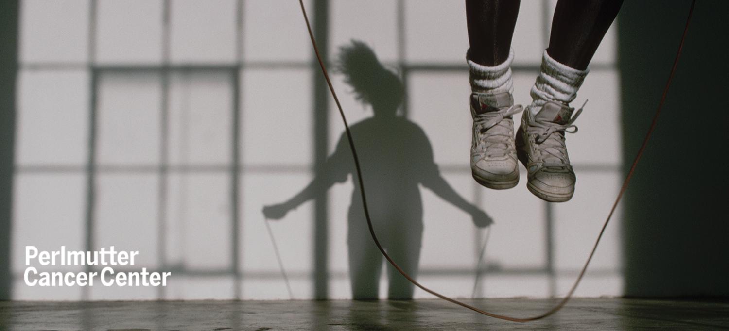 Person Skipping Rope, with Their Shadow on the Wall Behind Them
